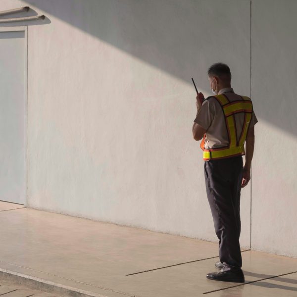 Security guard using walkie talkie while working in parking garage